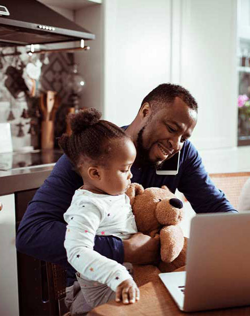 Working on laptop with child in lap